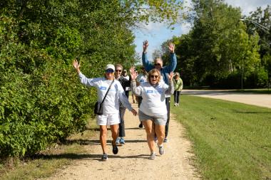 A group of walkers waving enthusiastically